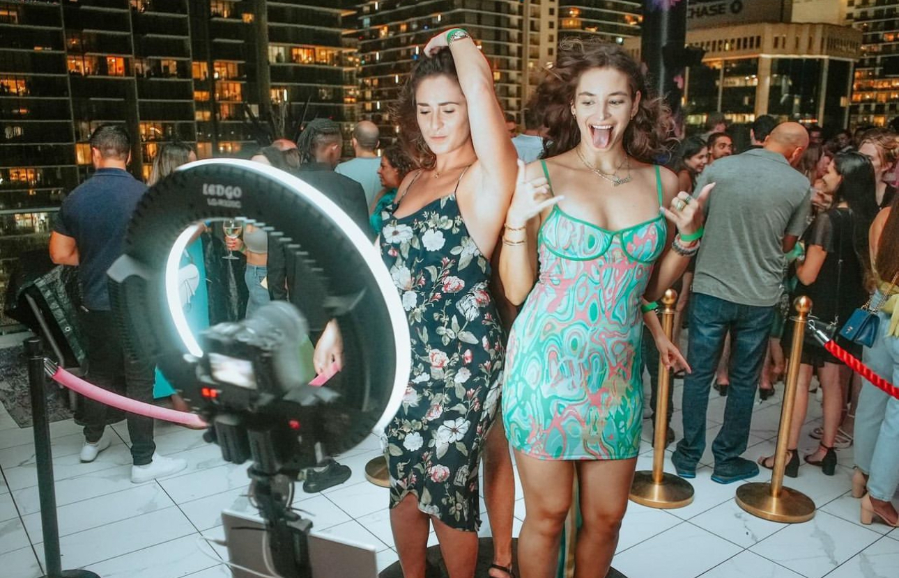 Guests posing at 360 photo booth rooftop party event