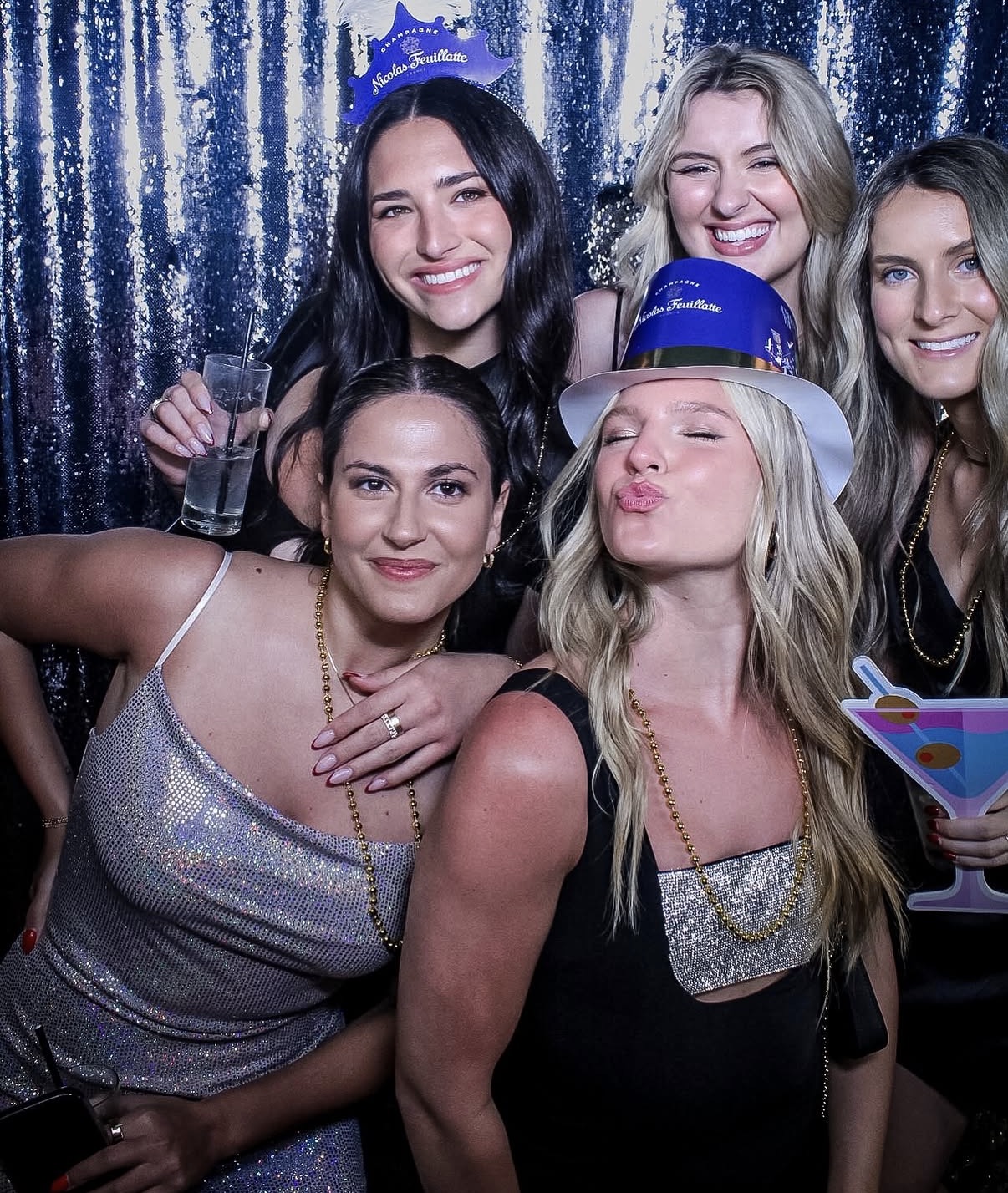 New Year's Eve party guests at shimmer backdrop photo booth